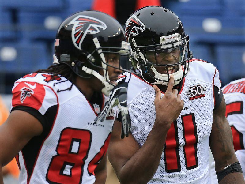 102515 NASHVILLE: -- Falcons wide receivers Roddy White and Julio Jones confer as they prepare to play the Titans in a football game on Sunday, Oct. 25, 2015, in Nashville. Curtis Compton / ccompton@ajc.com