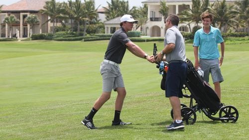Scott Geary congratulates Amadeo Figus after an American Junior Golf Association tournament. Geary has been named executive director of the Georgia PGA.