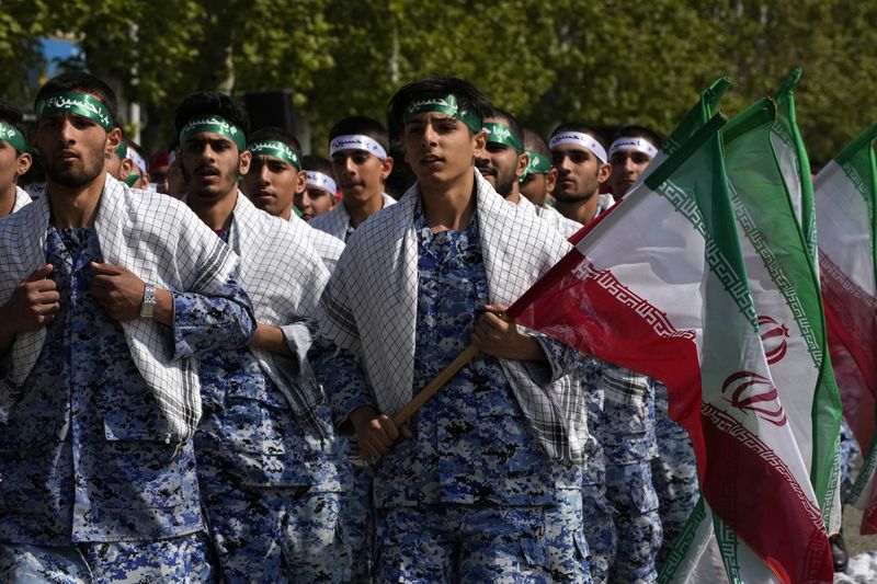 Volunteer troops of the Iranian army march during Army Day parade at a military base in northern Tehran, Iran, Wednesday, April 17, 2024. In the parade, President Ebrahim Raisi warned that the "tiniest invasion" by Israel would bring a "massive and harsh" response, as the region braces for potential Israeli retaliation after Iran's attack over the weekend. (AP Photo/Vahid Salemi)