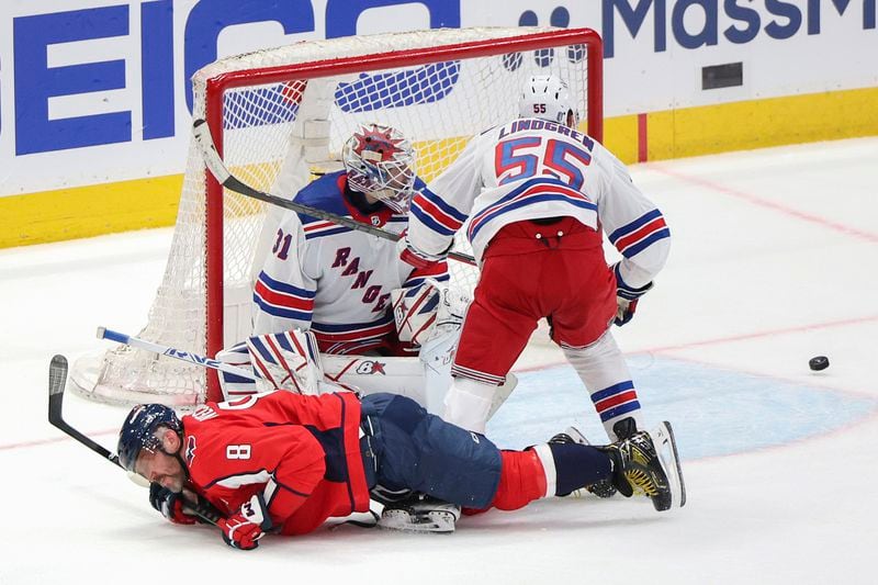 New York Rangers defenseman Ryan Lindgren (55) checks Washington Capitals left wing Alex Ovechkin (8) during the third period in Game 3 of an NHL hockey Stanley Cup first-round playoff series, Friday, April 26, 2024, in Washington. (AP Photo/Tom Brenner)