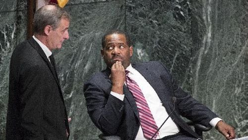 Atlanta Councilman Howard Shook (left) and council president Ceasar Mitchell confer during the Dec. 4 city council meeting, at which 288 employees were approved to buy back in to the city’s defined benefit pension system.