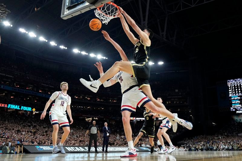 Purdue center Zach Edey dunks over UConn center Donovan Clingan, left, during the first half of the NCAA college Final Four championship basketball game, Monday, April 8, 2024, in Glendale, Ariz. (AP Photo/Brynn Anderson)