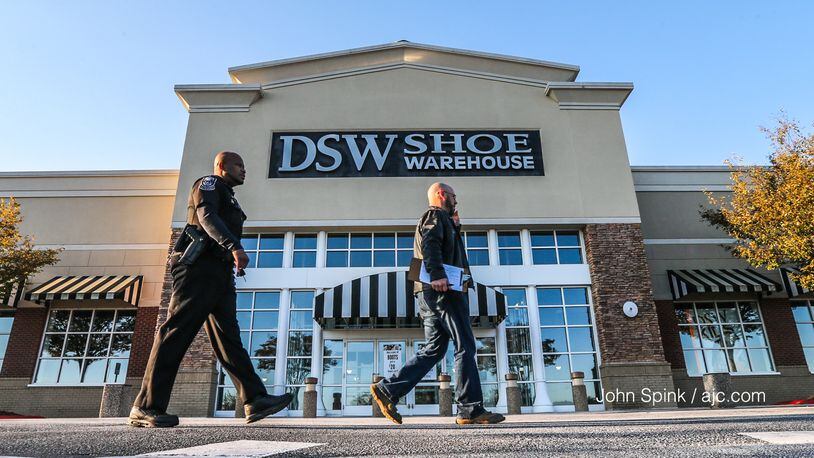 DeKalb County police officers canvass a DSW parking lot after a man was found shot to death.