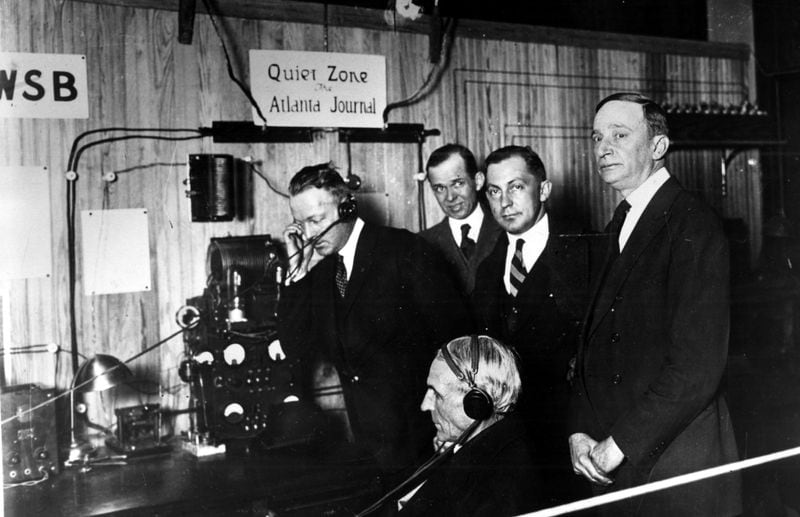 Henry Ford (seated) is shown in WSB's first studio in 1922 with Major John S. Cohen (right) then Journal editor and publisher. Others are Montgomery Haynes, Walker Lee and L.W. (Chip) Robert. (Lane Bros.)