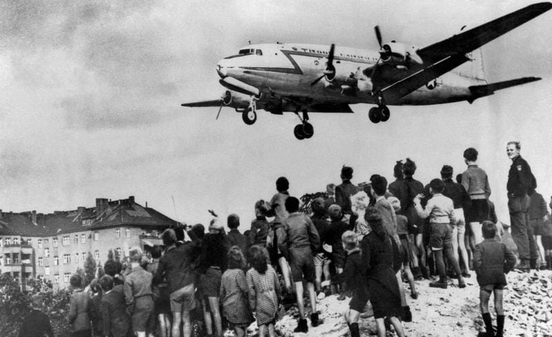 FILE - A U.S. Air Force C-54 Skymaster comes in to land at Berlin's Templehoff Air Base as a group of blockaded Berliners watch on Aug. 10, 1948. A Douglas C-54 Skymaster has crashed into the Tanana River outside Fairbanks, Alaska, not pictured. The C-54 is a military version of the Douglas DC-4, which was a World War II-era airplane. The website www.airlines.net said standard passenger seating for a DC-4 was 44 during its heyday, but most have been converted to freighters. (AP Photo/Henry Burroughs, File)