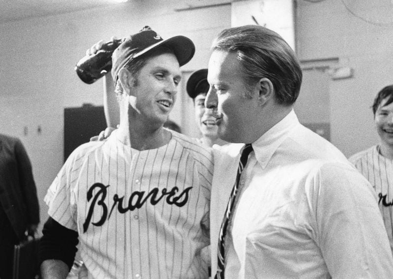Pitcher Hoyt Wilhelm (left) and Braves executive Bill Bartholomay celebrate in the Braves locker room in 1969. AJC file photo