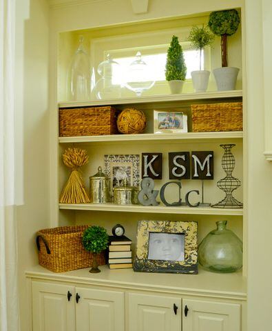 Tip: When styling bookshelves, cluster similar items, placing them in a zig-zag pattern, shelf by shelf