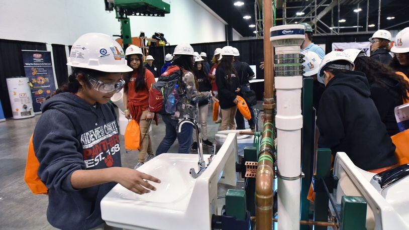 March 21, 2019 Atlanta - Xiomara Calleas (left), 11, student from Ridgeview Charter School in Sandy Springs, tries during 2019 CEFGA CareerExpo at Georgia International Convention Center on Thursday, March 21, 2019. Getting students career ready has taken on momentum in recent years — so much so that schools are starting as early as elementary school exposing kids to fields such as construction trades. The Construction Education Foundation of Georgia Career Expo draws schools across the state to learn about options. HYOSUB SHIN / HSHIN@AJC.COM