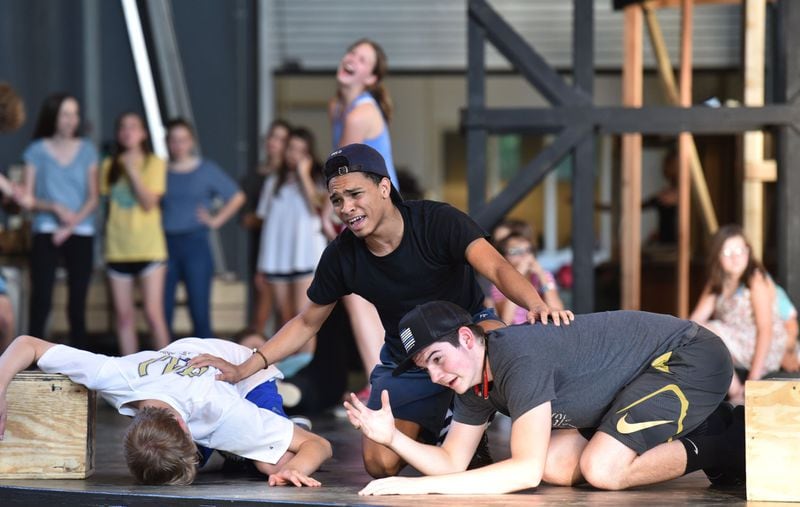 Jared Walker (center) during a rehearsal of “Joseph and the Amazing Technicolor Dreamcoat, ” at the Mable House Barnes Amphitheater in Mableton earlier this month. HYOSUB SHIN / HSHIN@AJC.COM