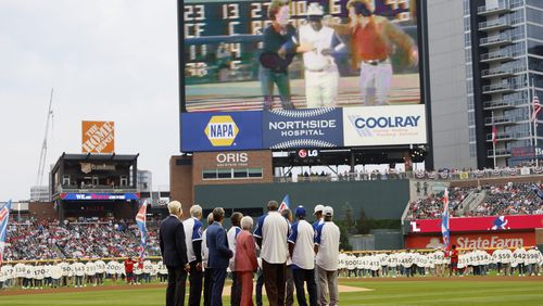 Billye Aaron and Hank’s former teammates and Gov. Brian Kemp watch the Jumbotron during the 50th-anniversary celebrations of Hank Aaron’s 715 home run record at Truist on Monday, April 8, 2024. 
Miguel Martinez / miguel.martinezjimenez@ajc.com 