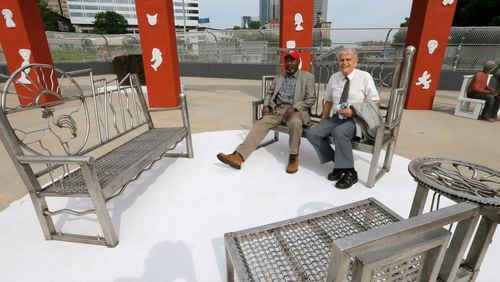 Artist Harold Rittenberry and original architect Bob Clements  sit among the welded stainless steel benches created by Rittenberry.   Folk Art Park, GDOT's first public art project and created in 1996 as part of the city's Olympics projects, reopened June 1.