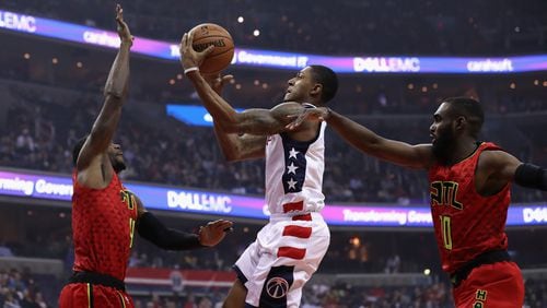 Bradley Beal of the Washington Wizards puts up a shot in front of Paul Millsap and Tim Hardaway Jr. of the Atlanta Hawks in the first half during Game 5 of the Eastern Conference quarterfinals at Verizon Center on April 26, 2017 in Washington, DC. (Photo by Rob Carr/Getty Images)