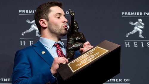 Oklahoma quarterback Baker Mayfield, winner of the Heisman Trophy, poses with the trophy in New York.  (AP Photo/Craig Ruttle, File)