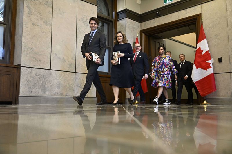 Canada's Prime Minister Justin Trudeau, left, Deputy Prime Minister and Minister of Finance Chrystia Freeland are joined by cabinet ministers for a photo before the tabling of the federal budget on Parliament Hill in Ottawa, Ontario, on Tuesday, April 16, 2024. (Justin Tang/The Canadian Press via AP)