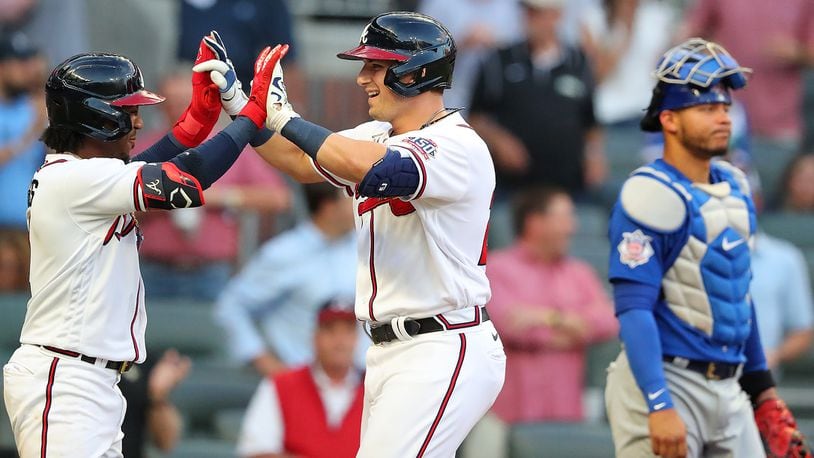Braves third baseman Austin Riley celebrates with teammate Ozzie Albies after hitting a two-run home run against the Chicago Cubs during the first inning Wednesday, April 28, 2021, at Truist Park in Atlanta. (Curtis Compton / Curtis.Compton@ajc.com)