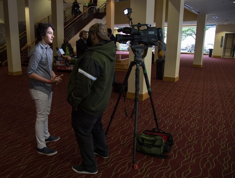 High school student and event organizer Royce Mann is interviewed in the lobby of the Rialto Center for the Arts before the start of the Town Hall For Our Lives Atlanta Saturday, April 7, 2018. Another metro Atlanta town hall was held earlier in the day in Conyers and included invited speaker U.S. Rep. Hank Johnson. Students organized the town halls across the nation on Saturday to spotlight gun violence and school safety.  STEVE SCHAEFER / SPECIAL TO THE AJC