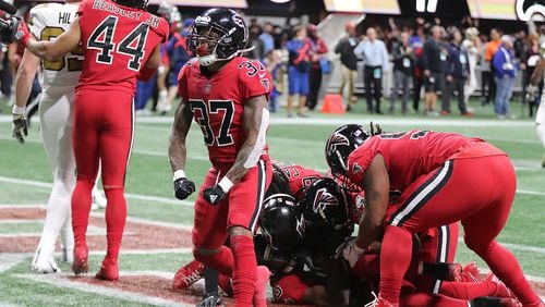 December 7, 2017 Atlanta: Ricardo Allen celebrates as Falcons linebacker Deion Jones hits the ground intercepting Saints quarterback Drew Brees pass intended for tight end Josh Hill in the endzone to hold on to a 20-17 victory in a NFL football game on Thursday, December 7, 2017, in Atlanta.  Curtis Compton/ccompton@ajc.com