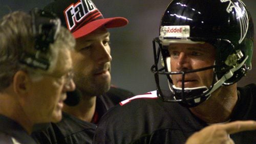Then Falcons backup quarterback Steve DeBerg, who came out of retirement at the age of 44 in 1998, consults with head coach Dan Reeves and quarterback Chris Chandler on the sideline of a game. DeBerg is the oldest quarterback to ever start an NFL game and oldest to be on a Super Bowl roster.