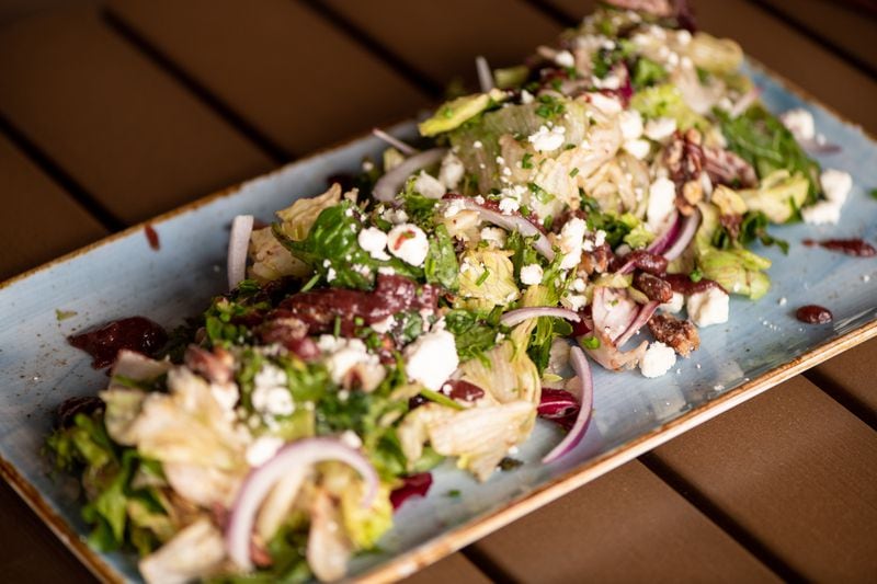 UP on the Roof's Harvest Salad captures fall/winter flavors with red onion, candied pecans, feta, apple, and cranberry vinaigrette. (Mia Yakel for The Atlanta Journal-Constitution)