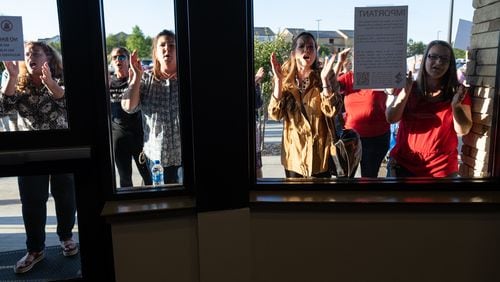 Parents who couldn’t get into the Cherokee County School Board meeting because the building reached capacity chant “No CRT!” during the meeting Thursday night, May 20, 2021. (Ben Gray for the Atlanta Journal-Constitution)