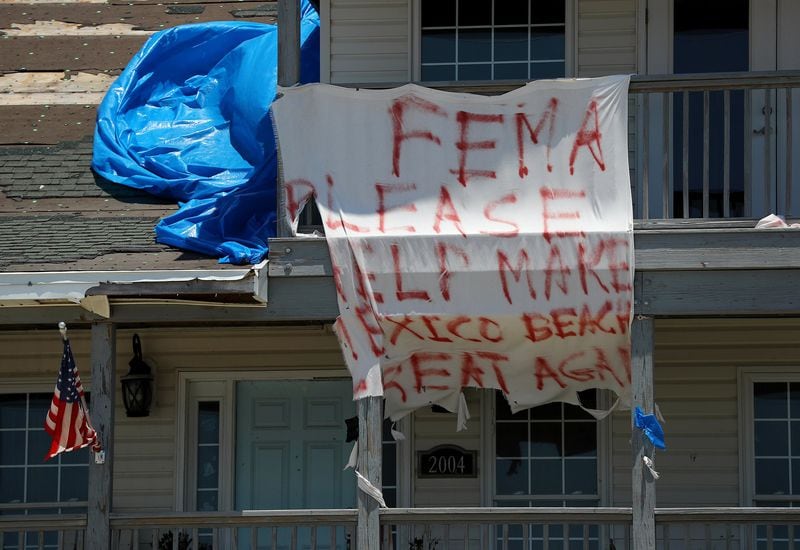 The plea on a tattered sign — “FEMA Please help make Mexico Beach great again” — hangs from a damaged home seven months after Hurricane Michael struck Mexico Beach in Florida. 