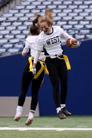 West Forsyth wide receiver Caroline Coggin celebrates with Abbylin Laprise, left, after Coggin scored a touchdown against Hillgrove during the first half of the Class 6A-7A Flag Football championship at Center Parc Stadium Monday, December 28, 2020 in Atlanta, Ga.. JASON GETZ FOR THE ATLANTA JOURNAL-CONSTITUTION