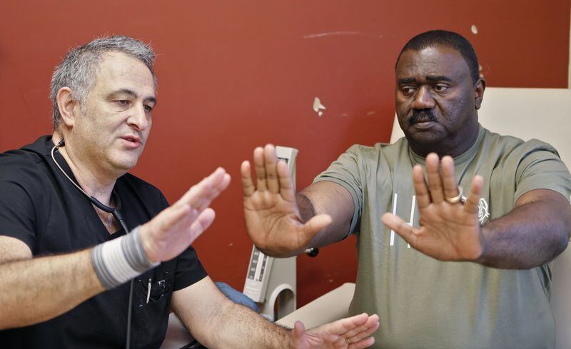 Former NFL player Willie Blackwell, who needs a kidney, is examined by Dr. Michael Katz in Stockbridge. After Blackwell was diagnosed with kidney cancer in 1999, he had that kidney removed. Now his other kidney is failing.