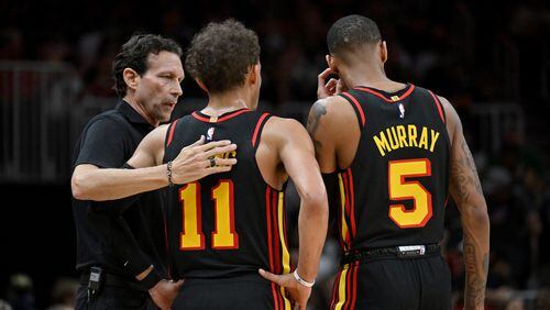 Atlanta Hawks head coach Quin Snyder confers with Atlanta Hawks' guard Trae Young (11) and Atlanta Hawks' guard Dejounte Murray (5) during the second half in Game 3 of the first round of the Eastern Conference playoffs at State Farm Arena, Friday, April 21, 2023, in Atlanta. Atlanta Hawks won 130-122 over Boston Celtics. (Hyosub Shin / Hyosub.Shin@ajc.com)