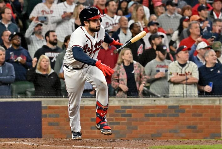 Atlanta Braves catcher Travis d'Arnaud (16) hits an RBI single against the Philadelphia Phillies during the sixth inning of game two of the National League Division Series at Truist Park in Atlanta on Wednesday, October 12, 2022. (Hyosub Shin / Hyosub.Shin@ajc.com)