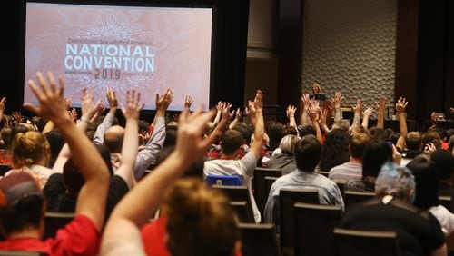 Delegates raise their hands in the American Sign Language sign for applause for speaker Sara Nelson, international president of the Association of Flight Attendants, during the Democratic Socialists of America National Convention at the Westin Hotel in Atlanta on Friday, August 2, 2019. (Photo; Christina Matacotta/Christina.Matacotta@ajc.com)