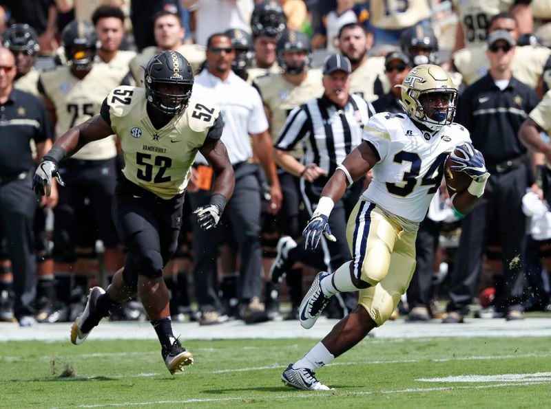 Georgia Tech running back Marcus Marshall (34) runs away from Vanderbilt linebacker Nigel Bowden (52) to score a touch down on a pass from quarterback Justin Thomas in the first half of an NCAA college football game Saturday, Sept. 17, 2016, in Atlanta. (AP Photo/John Bazemore)