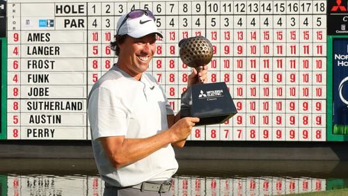 April 16, 2017, Duluth: Stephen Ames, Canada, is presented the trophy on the 18th green winning the Mitsubishi Electric Classic at TPC Sugarloaf with a 15-under par for a four stroke victory over second place finisher Bernhard Langer on Sunday, April 16, 2017, in Duluth.  Curtis Compton/ccompton@ajc.com