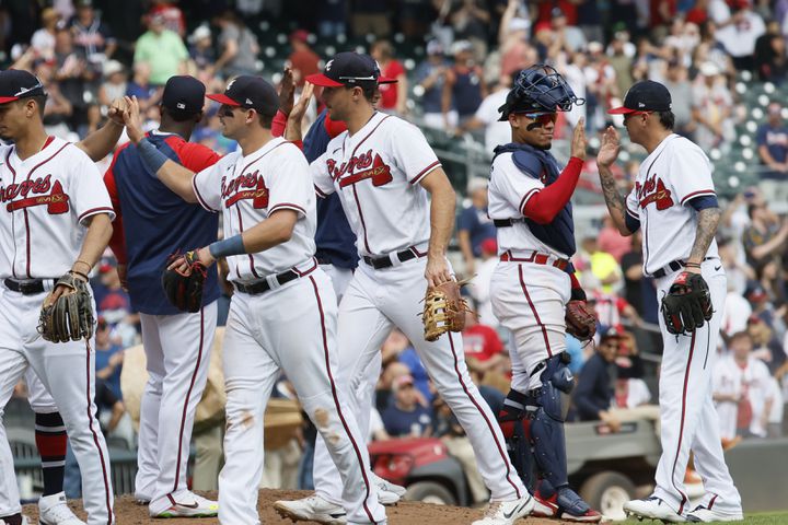 Braves players celebrate their victory and sweep against the Phillies on Sunday at Truist Park. (Miguel Martinez / miguel.martinezjimenez@ajc.com)