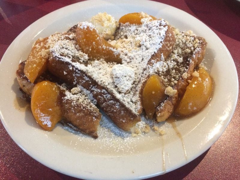 The peach cobbler French toast at Atlanta Breakfast Club is made with two of Georgia’s most famous ingredients: Peaches are cooked in a brown-butter sauce with a shot of Coca-Cola. CONTRIBUTED BY WENDELL BROCK