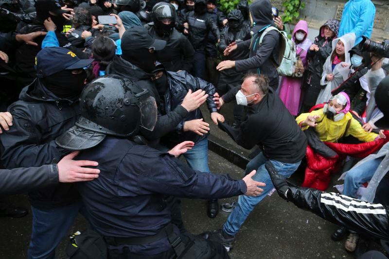 Police try to detain a demonstrator near the Parliament building during an opposition protest against "the Russian law" in the center of Tbilisi, Georgia, on Monday, May 13, 2024. Daily protests are continuing against a proposed bill that critics say would stifle media freedom and obstruct the country's bid to join the European Union. (AP Photo/Zurab Tsertsvadze)