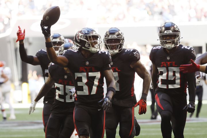 Dee Alford (37) and his teammates celebrate after Alford's second-half interception Sunday against the Browns at Mercedes-Benz Stadium. (Miguel Martinez / miguel.martinezjimenez@ajc.com)