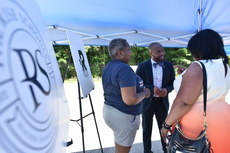 Davion Lewis (center), talks with guests during the RISE Schools groundbreaking ceremony at the school formerly called Latin Grammar School and Latin College Preparatory School in East Point on Friday, June 29, 2018. HYOSUB SHIN / HSHIN@AJC.COM