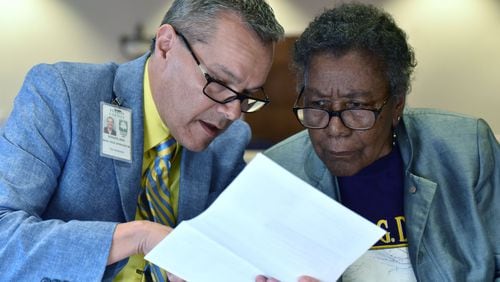 Emil Schultz (left), appraiser, helps Fulton County resident Marie F. Blake with her annual notice of assessment during Emergency Town Hall Meeting to discuss about Property Tax Assessments hosted by Fulton County Office of Chairman John Eaves at Harriett G. Darnell Senior Multipurpose Facility on Tuesday, June 13, 2017. HYOSUB SHIN / HSHIN@AJC.COM