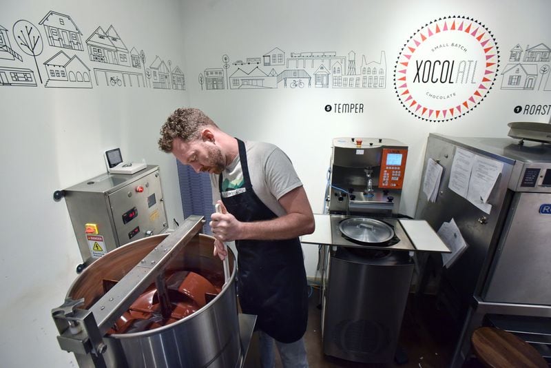 Matt Weyandt checks chocolate liquor at Xocolatl in Krog Street Market on Feb. 3, 2016. The owners of Xocolatl, Elaine Read and Weyandt, make bean-to-bar chocolate in Atlanta. HYOSUB SHIN / HSHIN@AJC.COM