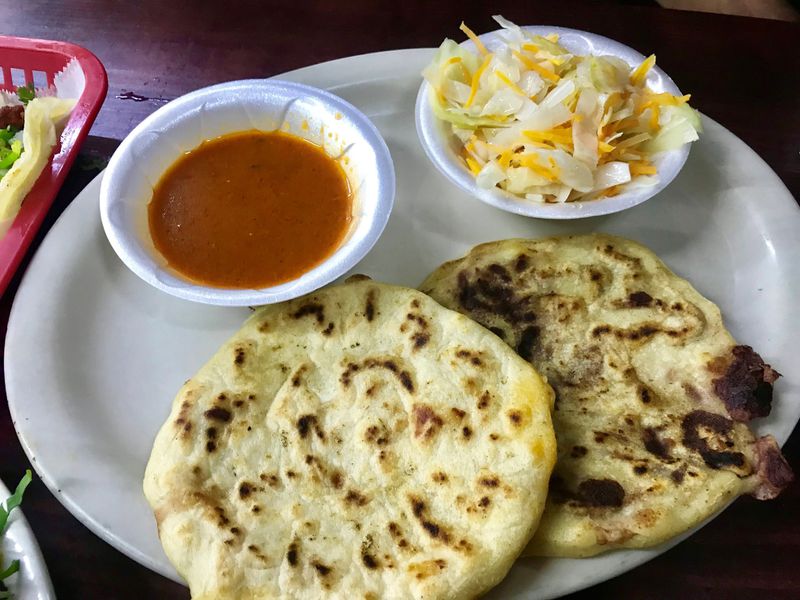 Pupusas (stuffed corn tortillas) come with a pickled cabbage slaw and a tomato sauce that gives new meaning to tomato sauce. This warm, cooked salsa de tomate is thin and holds moderate heat from jalapenos. It is intended as a sauce for the pupusa, but Dining editor Ligaya Figueras enjoyed it on many dishes, from tacos to empanadas. LIGAYA FIGUERAS / LFIGUERAS@AJC.COM