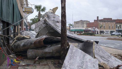 Debris lines the sidewalks on West Broad Avenue in Albany on Oct. 11 following Hurricane Michael. Georgia’s two U.S. senators unveiled a measure to provide funding for farmers in Georgia and other states recovering from Hurricane Michael. Estimates say damage from the storm could exceed $3 billion. (ALYSSA POINTER/ALYSSA.POINTER@AJC.COM)