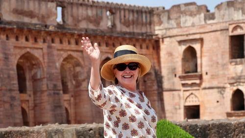 In this Monday, March 12, 2018 photo, former U.S. Secretary of State Hillary Clinton, waves to media as she visits the Jahaz Mahal monument in Mandu, Madhya Pradesh state, India. (AP Photo)