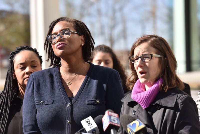 Allegra Lawrence-Hardy (foreground left), campaign chairwoman for former gubernatorial candidate Stacey Abrams, reacts as Lauren Groh-Wargo (right), CEO of Fair Fight Action and Abrams’ campaign manager, speaks to members of the press outside the Richard B. Russell Federal Building in Atlanta on Tuesday, Nov. 27, 2018. A federal lawsuit backed by Abrams will attempt to overhaul the state’s elections, alleging “gross mismanagement” after Georgians suffered long lines, uncounted ballots and purged registrations during this month’s vote. HYOSUB SHIN / HSHIN@AJC.COM