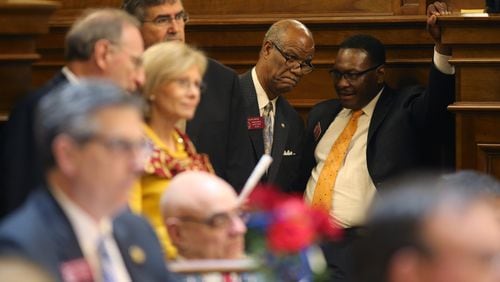 April 2, 2015 Atlanta: Reps. Calvin Smyre (D-Columbus), left, and Winfred Dukes (D-Albany) confer in the back of the House chamber late Thursday evening April 2, 2015. Ben Gray / bgray@ajc.com