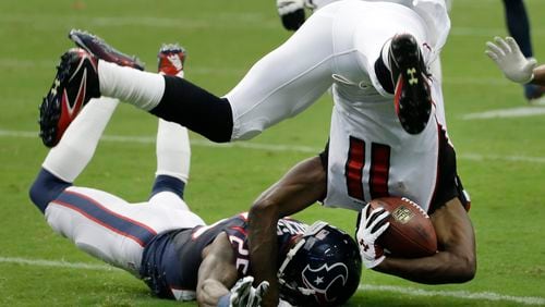 Atlanta Falcons' Julio Jones (11) is upended by Kareem Jackson (25) during the first quarter of an NFL preseason football game Saturday, Aug. 16, 2014, in Houston. (AP Photo/David J. Phillip)