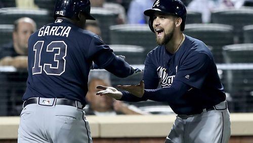 Ender Inciarte celebrates with Adonis Garcia after Garcia’s three-run homer that powered the Braves’ Tuesday win against the Mets. It was Inciarte who drove in the winning run Wednesday, then made the catch of the season for the Braves to rob Yoenis Cespedes of a would-be game-winning homer for the final out of a 4-3 win that gave the Braves a sweep of the Mets. (Getty Images)