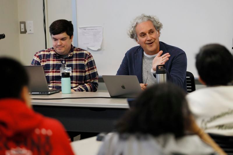 Georgia Tech professor Mark Leibert (right) and Ethan Trewhitt, senior research engineer at Georgia Tech Research Institute, interact with students during an Art & Artificial Intelligence project session on Jan. 31, 2022, Miguel Martinez / miguel.martinezjimenez@ajc.com