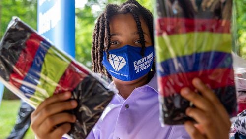 Young philanthropist, 11-year-old Malon James is at a Families First event in Norcross where he is giving away quality masks for to those in need Thursday, April 29, 2021.  The non-profit organization has received grant funding and is serving underprivileged communities.  (Jenni Girtman for The Atlanta Journal-Constitution)