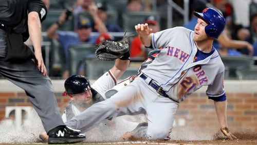 August 13, 2019 Atlanta: Atlanta Braves catcher Brian McCann tags New York Mets Todd Frazier out at the plate on a throw from Ronald Acuna Jr. during the sixth inning in a MLB baseball game on Tuesday, August 13, 2019, in Atlanta.   Curtis Compton/ccompton@ajc.com