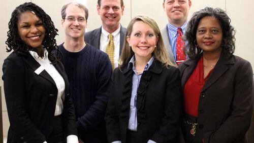 Decatur’s school board,l-r, Tasha White, Co-Chair Garrett Goebel, Lewis Jones, Chair Annie Caiola, Superintendent David Dude and Bernadette Seals. Board members, not counting Dude, make $50 per meeting. Though three seats are up for election—Jones and Caiola, with Seals retiring—only one candidate qualified. Courtesy City Schools Decatur